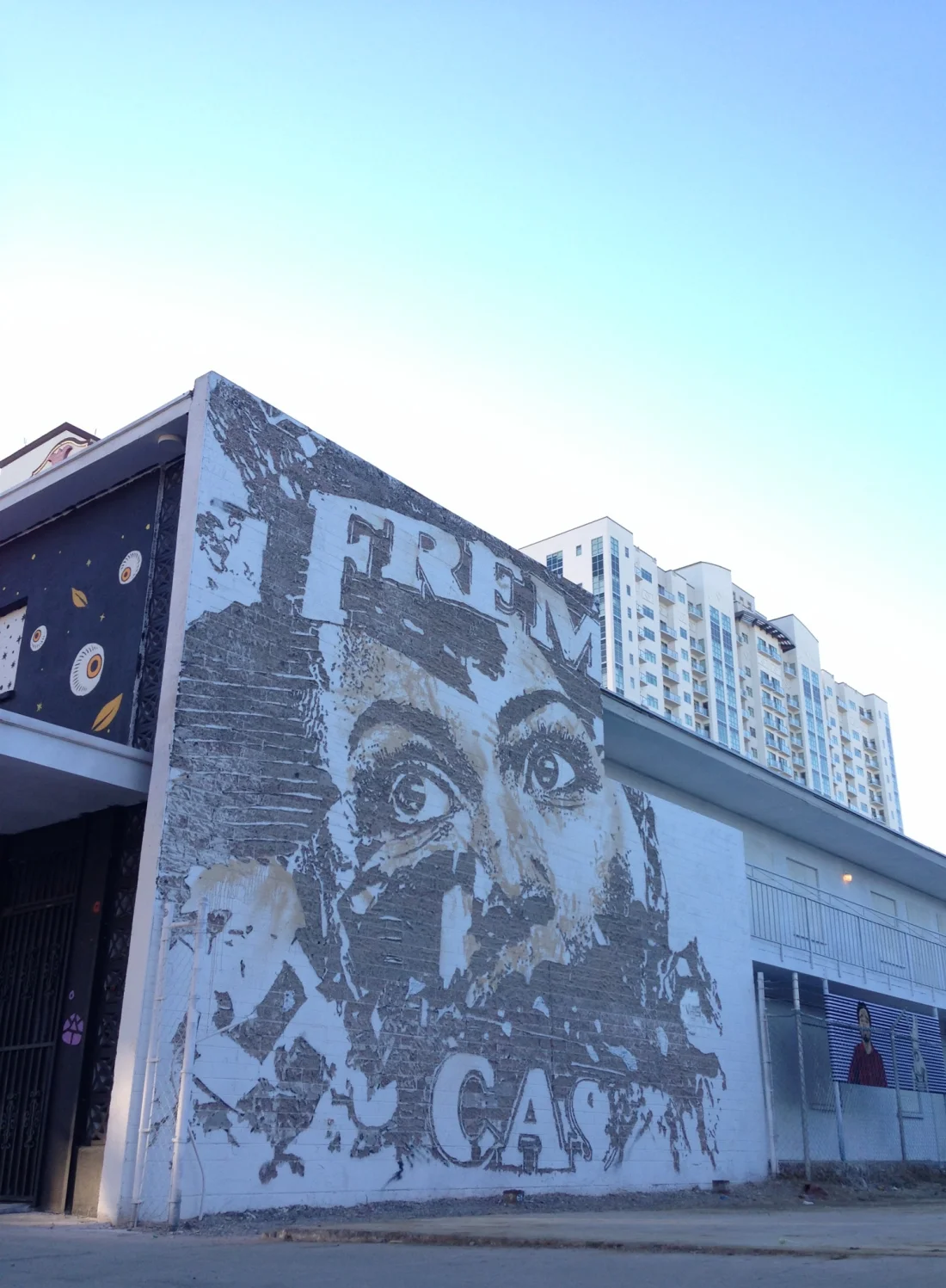 A monumental Vhils face carved into a building